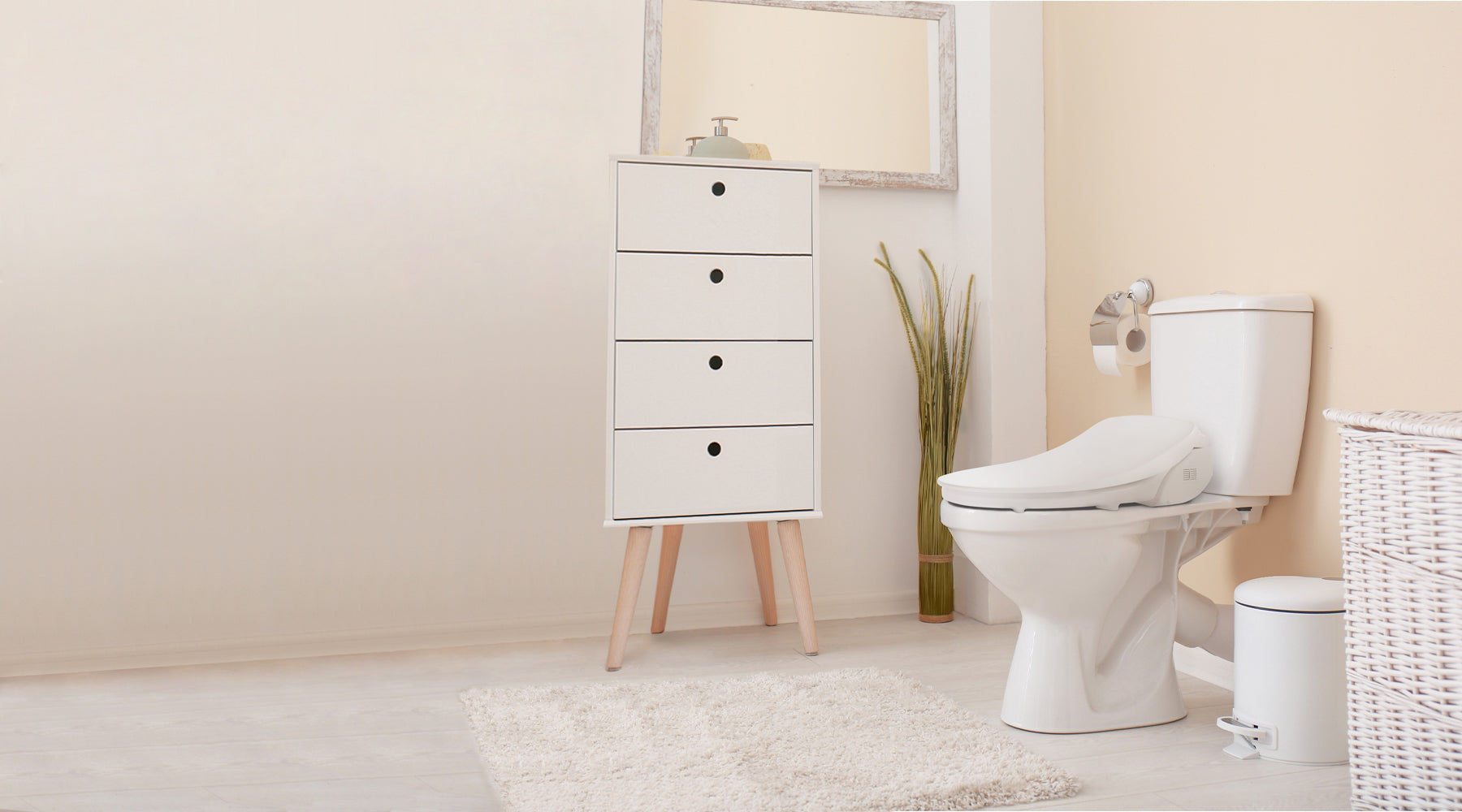 A Slim Three bidet seat installed on a toilet in a white and cream-colored chic bathroom.