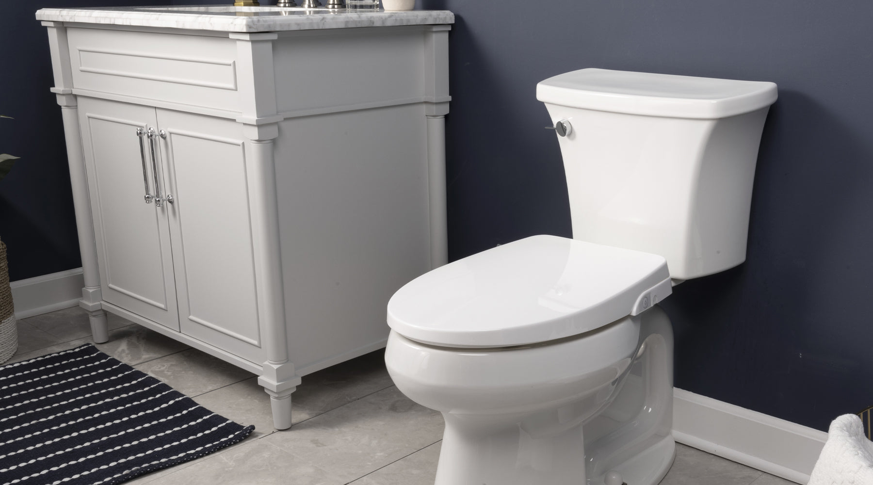 An HD-5000 bidet seat installed on a two-piece toilet in a navy blue bathroom with a white sink.
