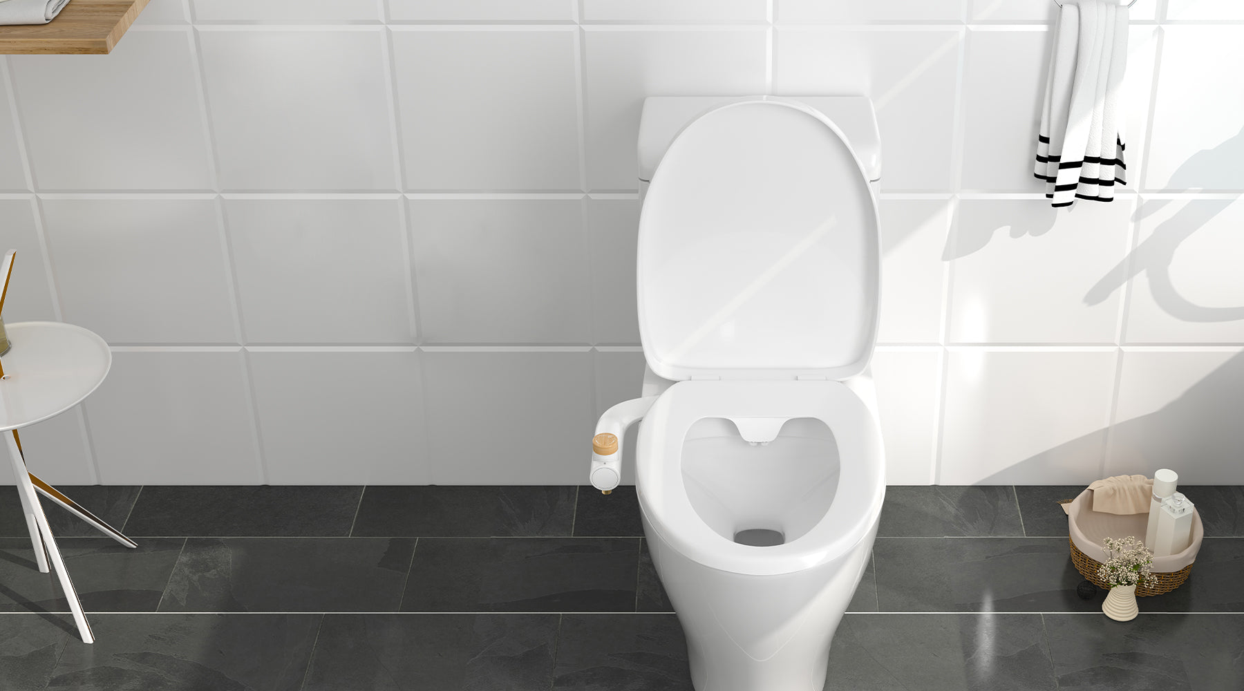 Downward shot of an open toilet with the Essential Bidet Attachment in a gray and white bathroom.